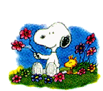 Snoopy sitting in a garden.